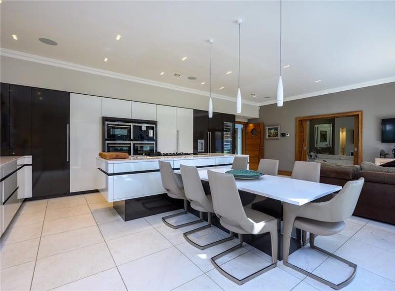 Kitchen/dining/family room. The kitchen is fitted with a range of units and surfaces and latest appliances, as well as a double sink with boiling water tap and waste disposer.