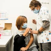 HADERA, ISRAEL - NOVEMBER 24:  Israeli child Liron Nurjits, 11, recieves a Pfizer-BioNTech Covid-19 vaccine from a Clalit health provider worker on November 24, 2021 in Hadera, Israel. People aged 12 and up in Israel are already eligible for the two-dose Pfizer-BioNTech vaccine and a follow-up booster.  (Photo by Amir Levy/Getty Images)