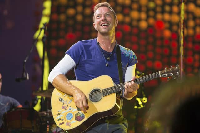 FILE - Chris Martin of Coldplay performs at Metlife Stadium on Aug. 1, 2017, in East Rutherford, N.J.  Coldplay's latest album, Music of the Spheres, releases Oct. 15.  (Photo by Scott Roth/Invision/AP, File)