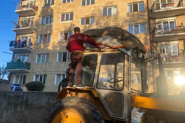 Ethnic Armenians put their belongings on a tractor as they evacuate from Stepanakert. Armenia said on Wednesday that 42,500 refugees have arrived from Nagorno-Karabakh since Azerbaijan's lightning offensive, representing a third of the separatist ethnic Armenian enclave's population.