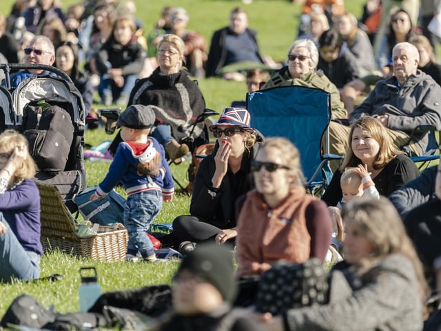 Members of the public watch Queen Elizabeth II's state funeral live in Holyrood Park