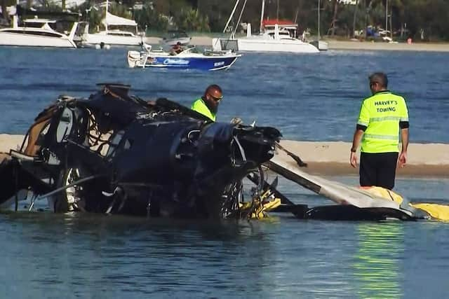 A British couple were among four killed in a mid-air collision that left two mangled helicopters on a sandbank near an Australian tourist hotspot, investigators said. (Photo by Handout / ABC / AFP via Getty Images)