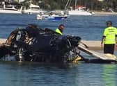 A British couple were among four killed in a mid-air collision that left two mangled helicopters on a sandbank near an Australian tourist hotspot, investigators said. (Photo by Handout / ABC / AFP via Getty Images)
