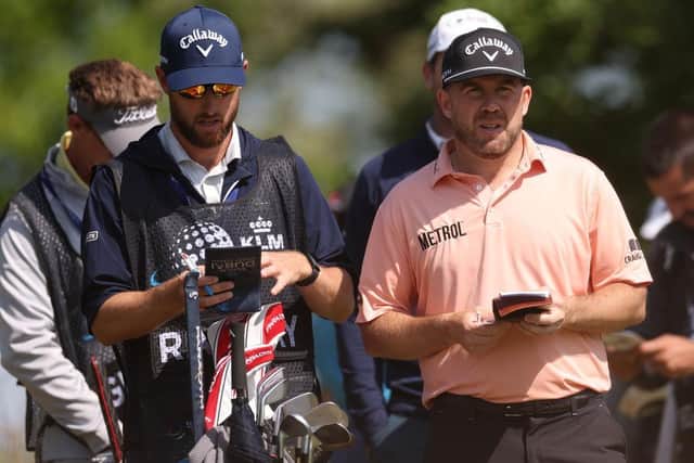 Richie Ramsay checks a yardage with caddie Scott Carmichael in the second round of the KLM Open at Bernardus Golf. Picture: Dean Mouhtaropoulos/Getty Images.