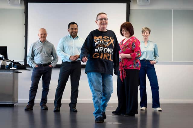 Jeanette Russell walking with confidence in her new footwear as the Health Design Collective team assess