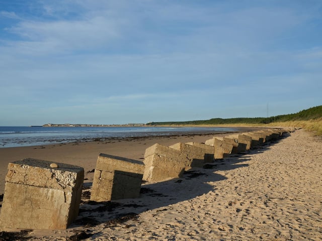 Located in Duffus, near Elgin in Moray, the six-mile long unspoilt beach at Roseisle is lined with majestic Scots pine trees. The hundreds of concrete anti-tank blocks left over from World War Two make excellent picnic tables.