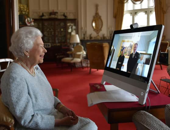 Queen Elizabeth II, at Windsor Castle, speaks to His Excellency Dr. Ferenc Kumin, Ambassador of Hungary, and his wife, Viktoria. Picture: Buckingham Palace/AFP via Getty