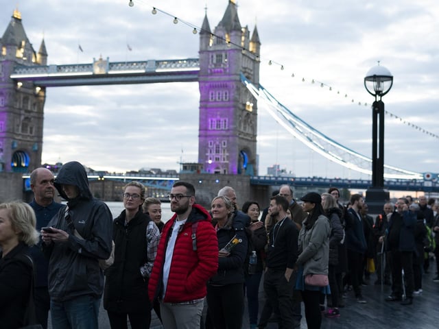 Members of the public in the queue at 06:19 on The Queen's Walk by Tower Bridge in London, as they wait to view Queen Elizabeth II lying in state ahead of her funeral on Monday. Picture date: Friday September 16, 2022.