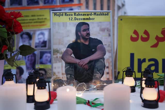 A photograph of Majidreza Rahnavard, 23, stands on a table among candles during a demonstration by supporters of the National Council of Resistance of Iran in Berlin (Picture: Sean Gallup/Getty Images)