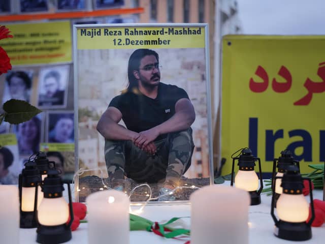 A photograph of Majidreza Rahnavard, 23, stands on a table among candles during a demonstration by supporters of the National Council of Resistance of Iran in Berlin (Picture: Sean Gallup/Getty Images)