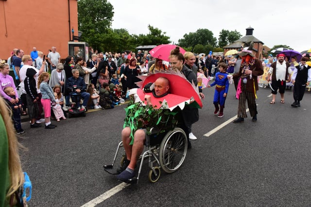 Despite the rain, people still turned out to take part and watch the grand fancy dress parade.