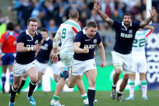 The celebrations begin for Duncan Weir and Scotland team-mates Stuart Hogg and Jim Hamilton after the late, late drop goal. Picture: Paolo Bruno/Getty Images