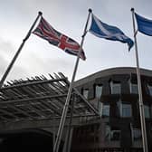 A Union Jack, Saltire and Flag of Europe fly outside the entrance to the Scottish Parliament (Picture: Andy Buchanan/AFP via Getty Images)