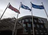 A Union Jack, Saltire and Flag of Europe fly outside the entrance to the Scottish Parliament (Picture: Andy Buchanan/AFP via Getty Images)