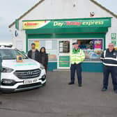 Rod Moore, pictured first left, helped so many people during his long career with the Scottish Ambulance Service and even took the time to praise other people's live saving efforts as he did here back in March - applauding Stenhousemuir's Day Today store after it installed a defibrillator