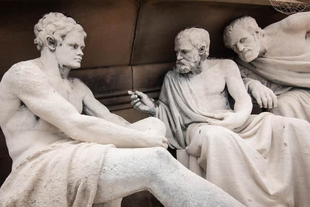 Figures from Ancient Greece in deep conversation above the streets of Preston