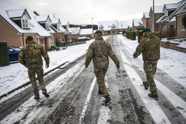 Marines from 45 Commando conduct welfare checks in Lumphanan, Aberdeenshire, after Storm Arwen left many people without power (Picture: Peter Summers/Getty Images)
