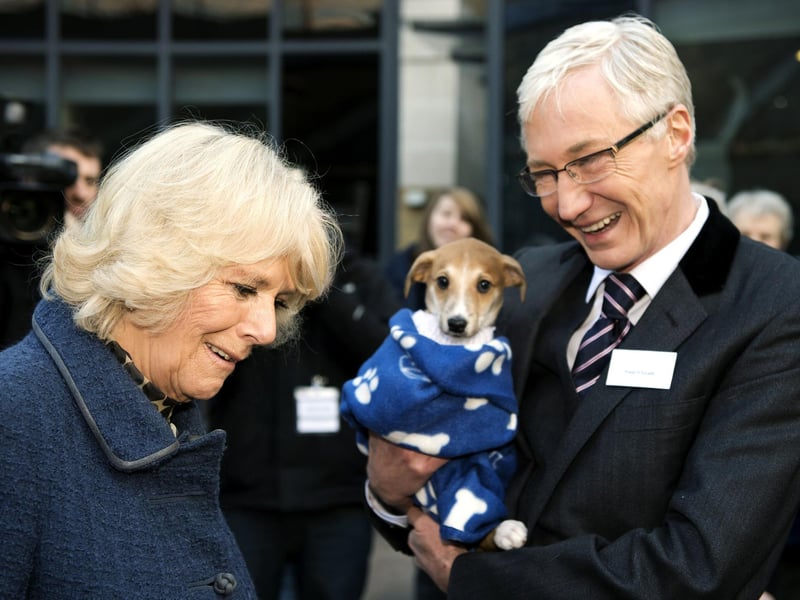 The Queen Consort, then the Duchess of Cornwall, with television presenter Paul O'Grady during her visit to Battersea Dogs & Cats Home in London. TV presenter and comedian Paul O'Grady has died at the age of 67, his partner Andre Portasio has said.