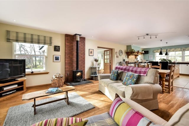 The open plan living room, dining area and kitchen runs the length of the house.