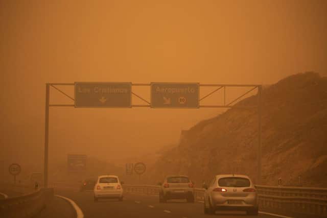 Cars drive on the TF-1 highway during a sandstorm in Santa Cruz de Tenerife, on the Canary Island of Tenerife (Photo: DESIREE MARTIN/AFP via Getty Images)