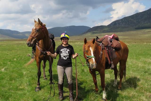 Claire holding Yogi and Swift. The full-time paramedic has written a book about her adventures titled 'From East to West by Saddle is Best' picture: Claire Alldritt