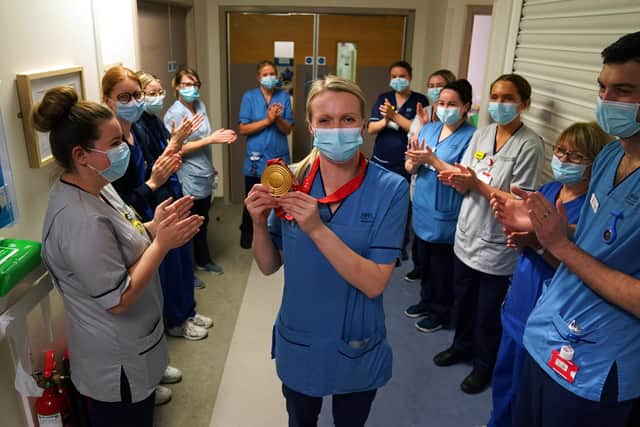 Vicky Wright is clapped onto the ward by colleagues as she returns to the wards.