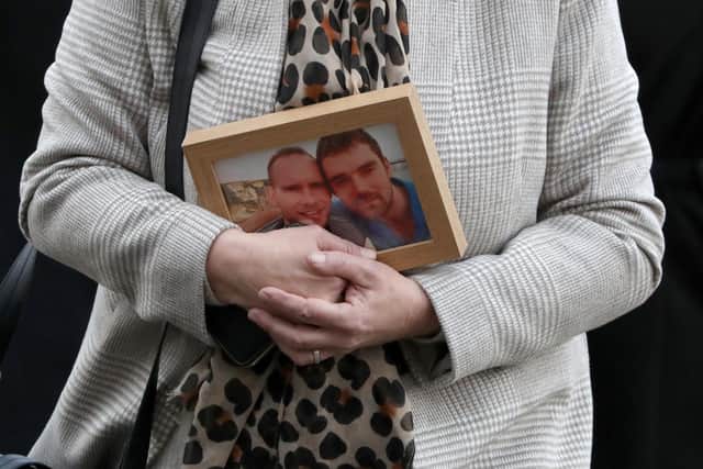 Victim Simon Midgley's mother, Jane Midgley, carries a photograph of him and second victim Richard Dyson as she arrives at Dumbarton Sheriff Court on January 29, 2021. Picture: Press Association