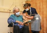 88-year-old Trevor Cowlett receives the Oxford University/AstraZeneca Covid-19 vaccine from nurse Sam Foster. Picture: PA