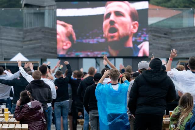 England fans watch the England v Germany Euro 2020 match on a big screen in a fan zone on Hastings pier