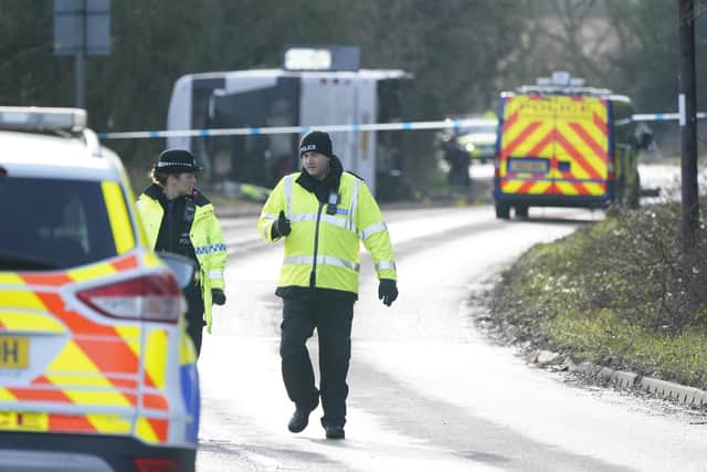 Police at the scene on the A39 Quantock Road in Bridgwater after a double-decker bus overturned in a crash involving a motorcycle. Picture date: Tuesday January 17, 2023.