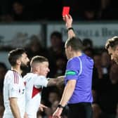 Aberdeen's Graeme Shinnie sees red for a late challenge on Jack Baldwin following a VAR check in the 1-0 win at Ross County.  (Photo by Mark Scates / SNS Group)