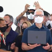 Apple chief executive Tim Cook (centre) holds a newly redesigned MacBook Air laptop. Picture: Justin Sullivan/Getty Images