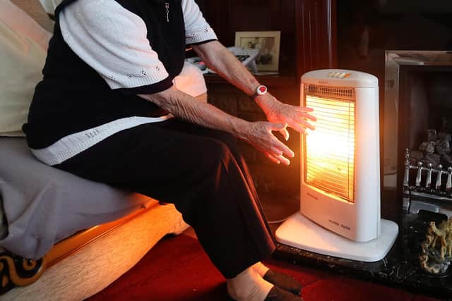 A stock photo of an elderly lady with her electric fire on at home, as cash-strapped Scots will have to fork out around £1,100 extra a year on staying warm and eating, it has been suggested as a new poll revealed nearly half are using their heating less to help make ends meet.