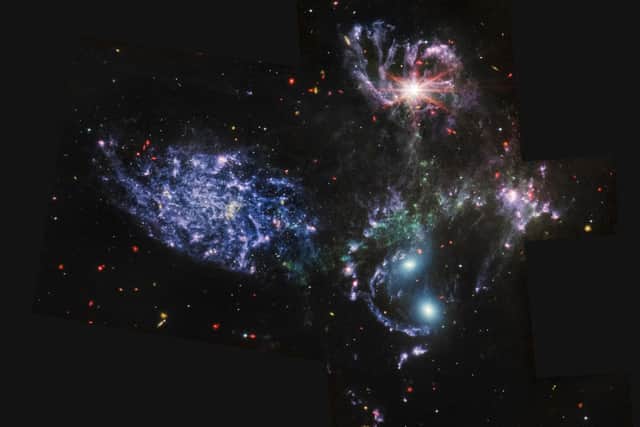 This image released by NASA on July 12, 2022, from the telescope's  Mid-Infrared Instrument (MIRI), which was largely designed and built in Edinburgh. It shows never-before-seen details of Stephans Quintet, a visual grouping of five galaxies. (Photo by Handout / NASA / AFP)