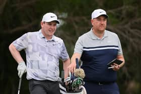 Bob MacIntyre talks with caddie Mike Burrows during a practice round prior to the Sony Open in Hawaii at Waialae Country Club in Honolulu. Picture: Michael Reaves/Getty Images.