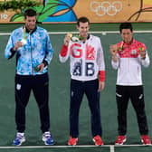 Andy Murray, centre, shows off his gold medal at the Rio 2016 Olympic Games.