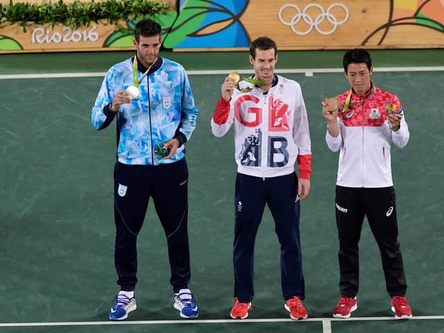 Andy Murray, centre, shows off his gold medal at the Rio 2016 Olympic Games.
