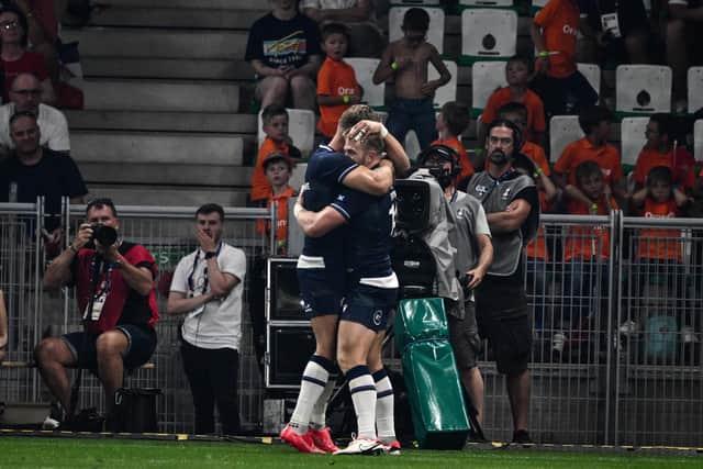 Scotland's wing Kyle Steyn (right) celebrates after scoring a try.