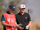 Connor Syme talks through a shot on the seventh tee at Yas Links with caddie Ryan McGuigan during day one of the Abu Dhabi HSBC Championship. Picture: Ross Kinnaird/Getty Images.