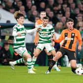 Celtic's Kyogo Furuhashi, left, and Greg Taylor close down Shakhtar's Heorhiy Sudakov in possession.