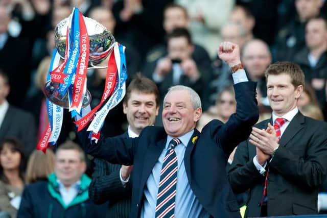 Walter Smith holds the League Cup aloft after nine-man Rangers' 1-0 win over St Mirren at Hampden in 2010. (Photo by Steve Welsh/SNS Group).
