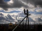 Workers repair power lines cut by shelling in the town of Kupiansk, Kharkiv region, which was formerly occupied by Russian forces.