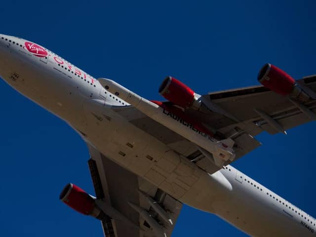 The Virgin Orbit - a modified Boeing 747 - carries a Launcher One rocket under it's wing containing small satellites to be sent into space. (Pic: Getty)