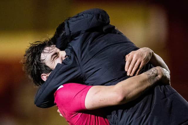 Brora manager Steven MacKay (R) and his players celebrate at full time during a Scottish Cup tie between Brora Rangers and Hearts at Dudgeon Park, on March 23, 2021, in Brora, Scotland. (Photo by Ross Parker / SNS Group)