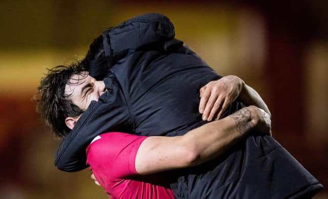 Brora manager Steven MacKay (R) and his players celebrate at full time during a Scottish Cup tie between Brora Rangers and Hearts at Dudgeon Park, on March 23, 2021, in Brora, Scotland. (Photo by Ross Parker / SNS Group)