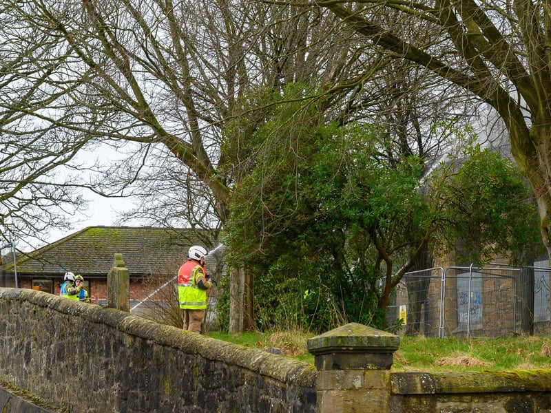 Firefighters in the graveyard surrounding Camelon St John's Church.