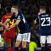 Scotland defender Ryan Porteous celebrates with Grant Hanley after victory over Spain.