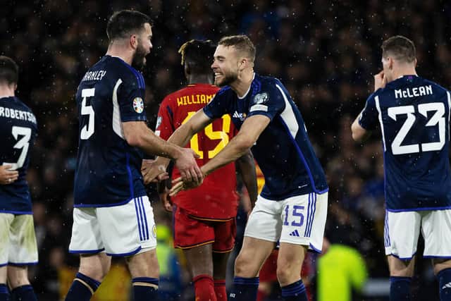 Scotland defender Ryan Porteous celebrates with Grant Hanley after victory over Spain.