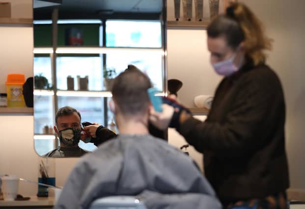 Hairdresser Dana Biezalo with her client Pietro at The Barbery in London. Picture: PA Media