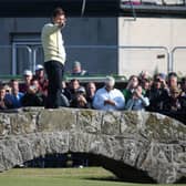 Sir Nick Faldo of England waves to the crowd as he stands on Swilcan Bridge during the second round of the 144th Open Championship at The Old Course on July 17, 2015 in St Andrews, Scotland